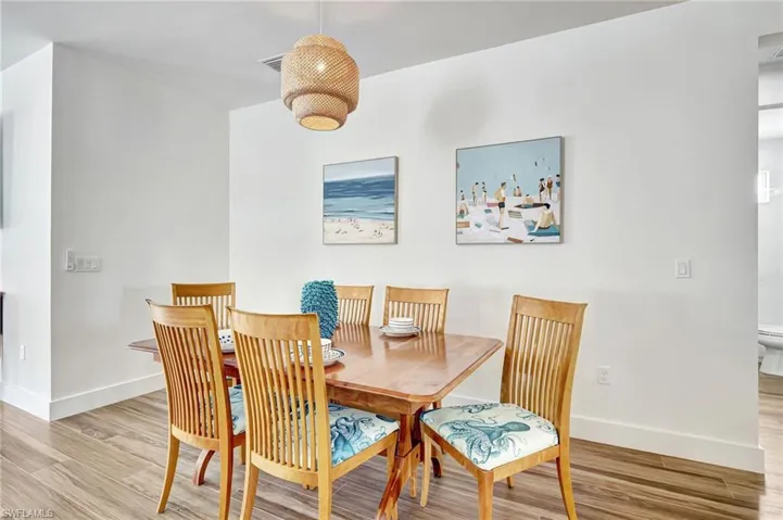 Dining space with light hardwood / wood-style flooring