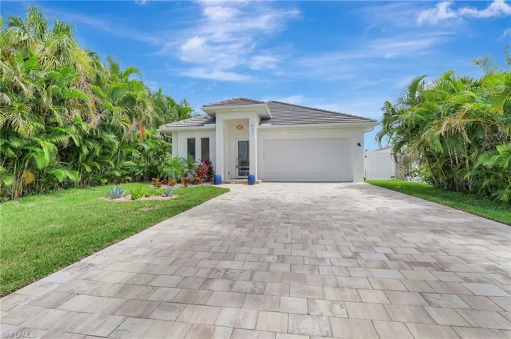 View of front of house with a garage and a front yard