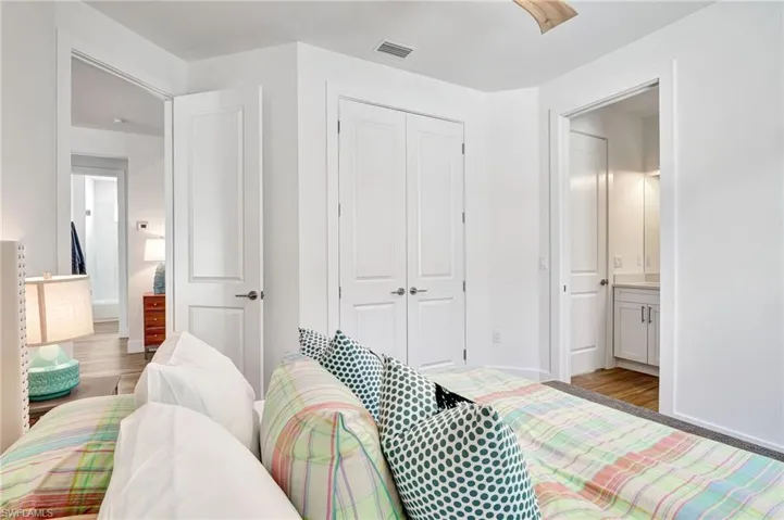 Bedroom with ensuite bathroom, a closet, and tile flooring