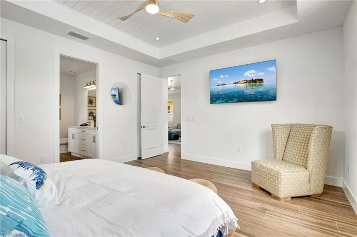 Master Bedroom featuring ceiling fan, ship lap tray 11' high ceiling.