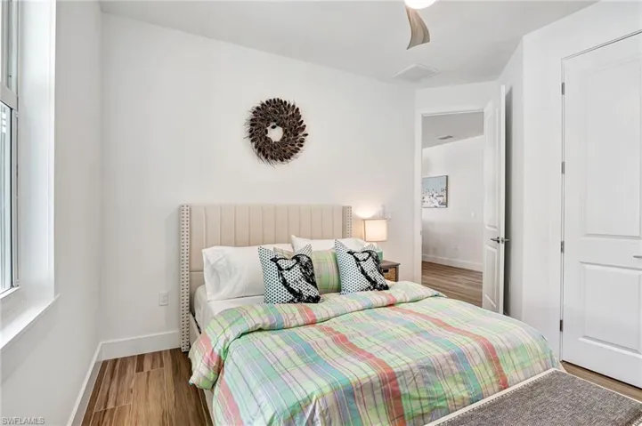 Bedroom with ceiling fan and hardwood / wood-style flooring