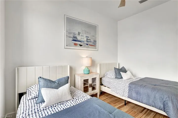 Bedroom with ceiling fan and hardwood / wood-style flooring