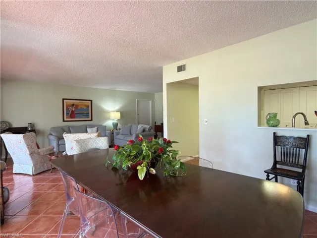 Tiled dining area with a textured ceiling