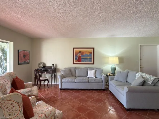 Tiled living area with a textured ceiling
