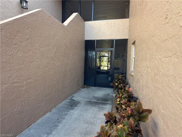 Property entrance featuring stucco siding