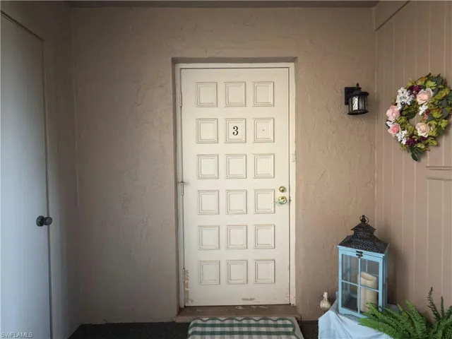 Doorway to property with stucco siding