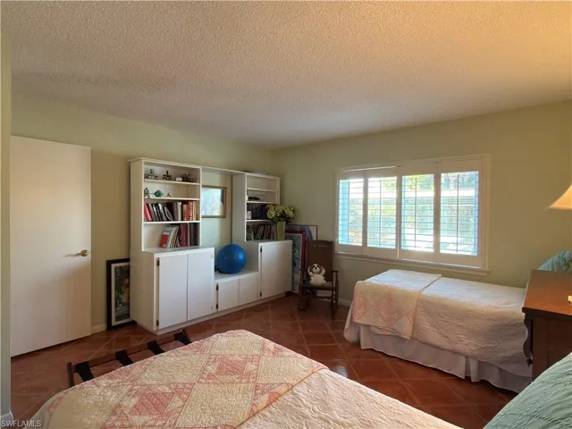Bedroom featuring a textured ceiling and tile patterned floors