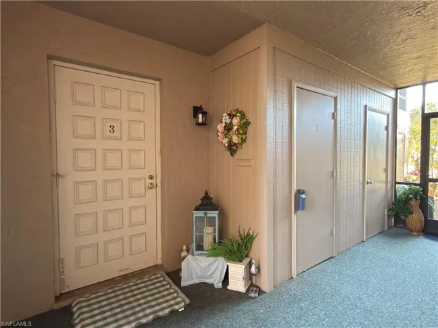 View of exterior entry featuring a sunroom