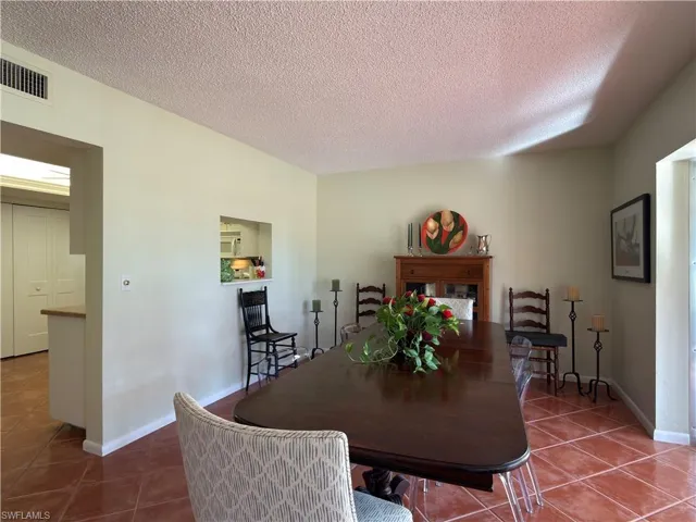 Dining space with tile patterned floors and a textured ceiling