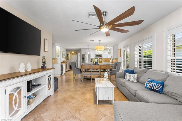 Living room with light tile flooring and ceiling fan
