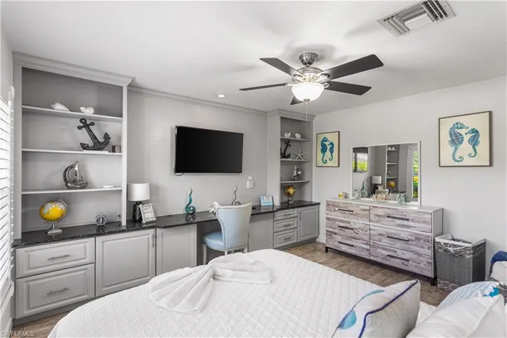 Bedroom featuring ceiling fan and hardwood / wood-style floors
