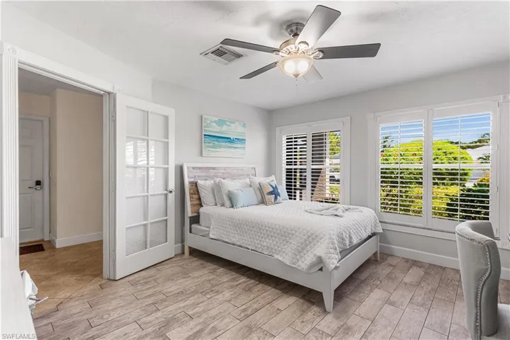 Bedroom with ceiling fan and light hardwood / wood-style flooring