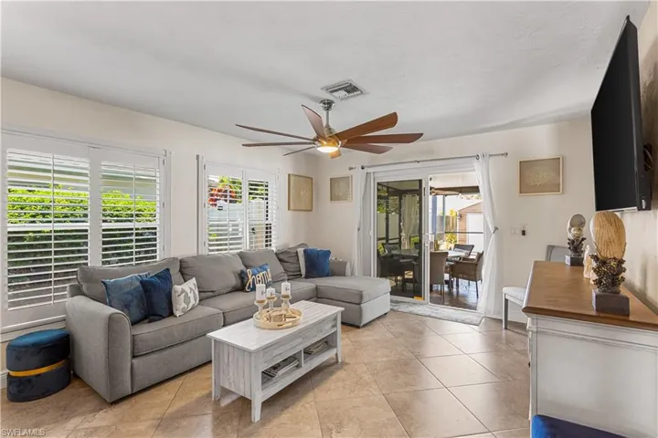 Living room featuring tile floors and ceiling fan