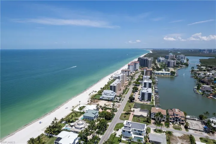 Drone / aerial view featuring a beach view and a water view