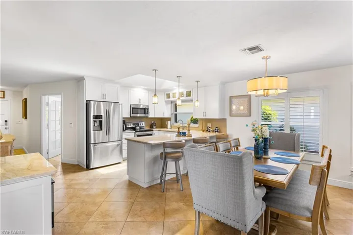 Dining room featuring sink and light tile flooring