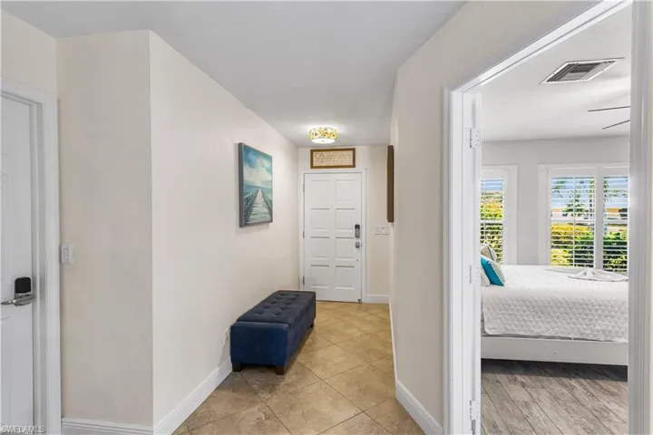 Hallway featuring light tile floors
