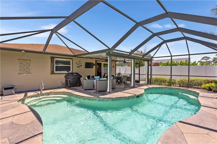 View of pool featuring a patio, a lanai, area for grilling, and an outdoor living space