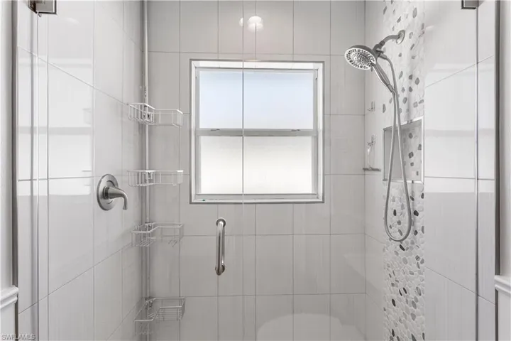 Bathroom with tiled shower and toilet