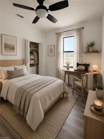 Well-lit bedroom featuring a black ceiling fan with integrated lighting, wood-finish flooring, and a window with sheer curtains