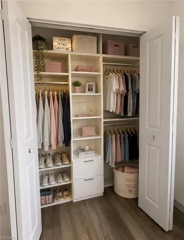 Custom closet system featuring built-in shelving, hanging rods, and integrated drawers