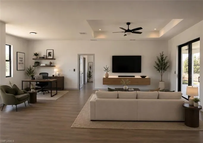 Spacious open-concept living area featuring wood-finish flooring, recessed lighting, and a contemporary ceiling fan