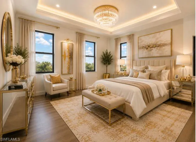 Recessed lighting within a tray ceiling, paired with a central chandelier, illuminates this space