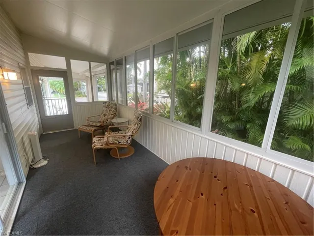 Sunroom featuring radiator heating unit and lofted ceiling