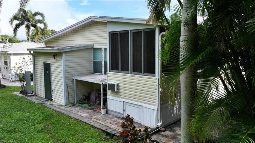 Rear view of property featuring a patio and a lawn