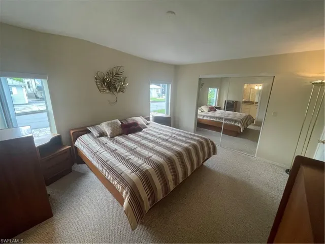 Bedroom featuring carpet and a closet