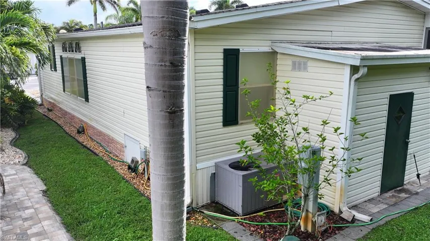 View of side of property featuring crawl space and a yard