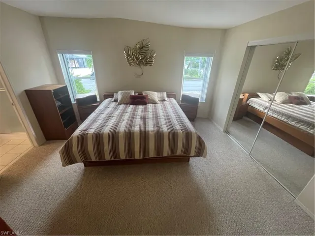 Bedroom featuring light colored carpet and a closet