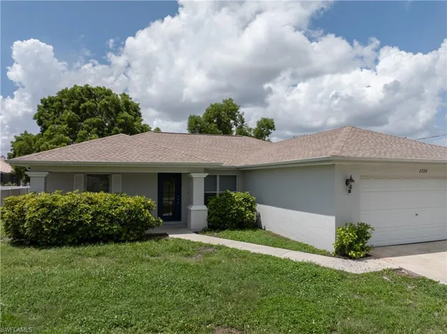 Mature landscape and a spacious 2 car garage