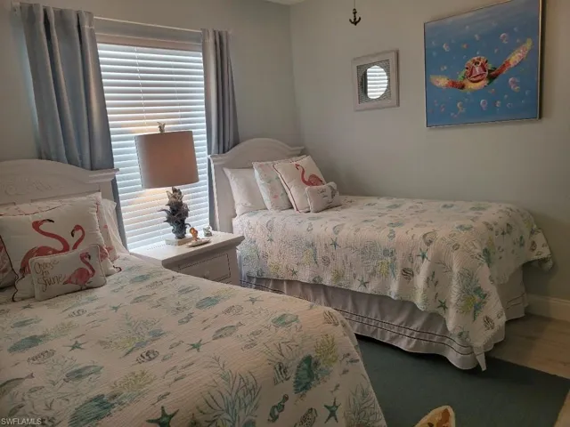 Bedroom with wood finished floors and baseboards
