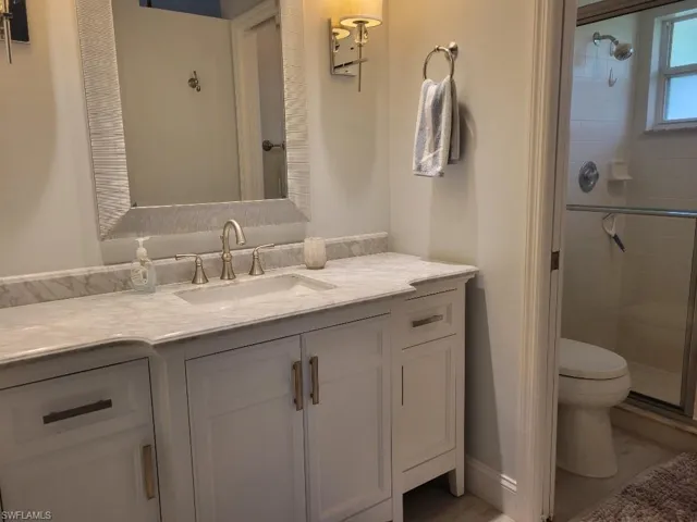 Full bathroom featuring a shower stall and vanity