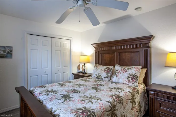 Bedroom with a closet, a ceiling fan, and baseboards