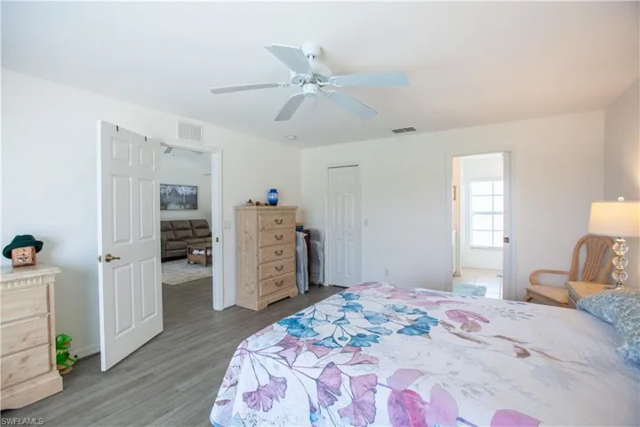 Bedroom with visible vents, a ceiling fan, baseboards, and light wood-type flooring