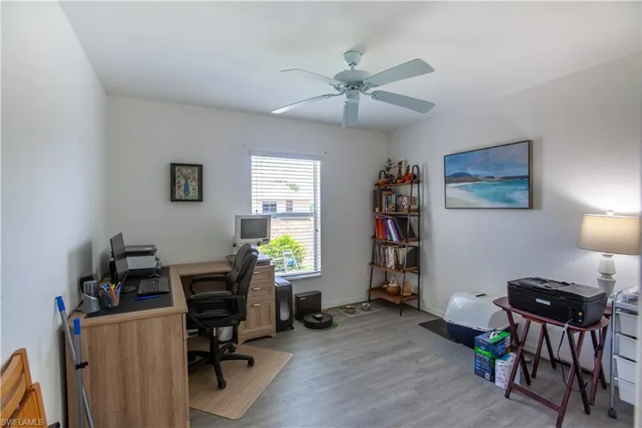 Home office featuring light wood-style floors, baseboards, and ceiling fan