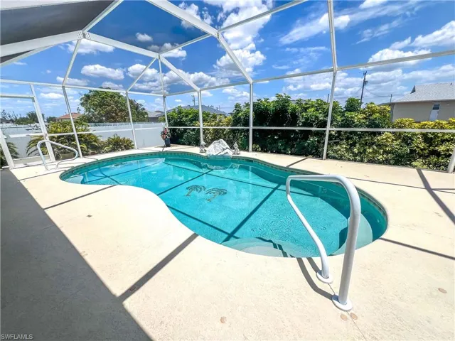 Outdoor pool with a lanai and a patio