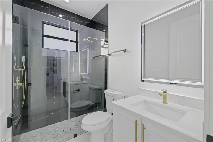 Full bath featuring vanity and a shower stall