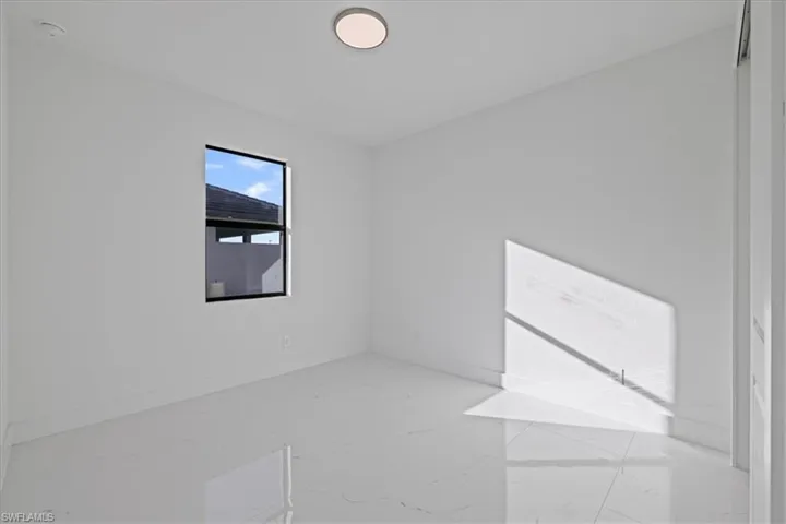 Unfurnished room featuring baseboards and marble finish flooring