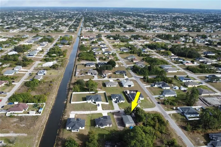 Aerial overview of property's location featuring nearby suburban area