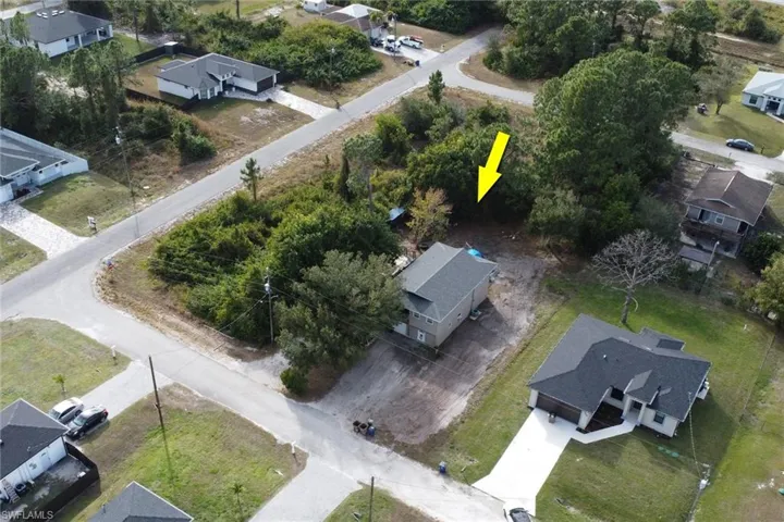Aerial view of property and surrounding area with nearby suburban area