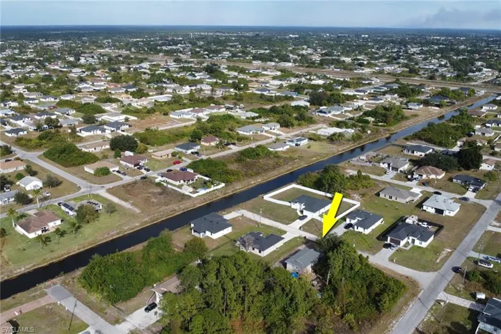 Aerial view of property's location with nearby suburban area and a nearby body of water