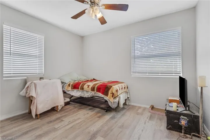 Bedroom with a ceiling fan and light wood finished floors