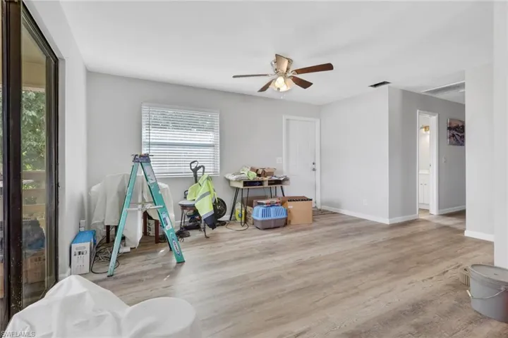 Game room with ceiling fan and wood finished floors