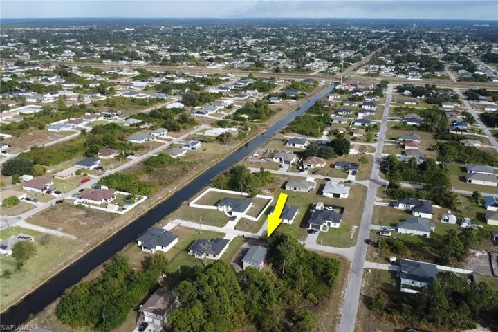 Aerial overview of property's location featuring nearby suburban area