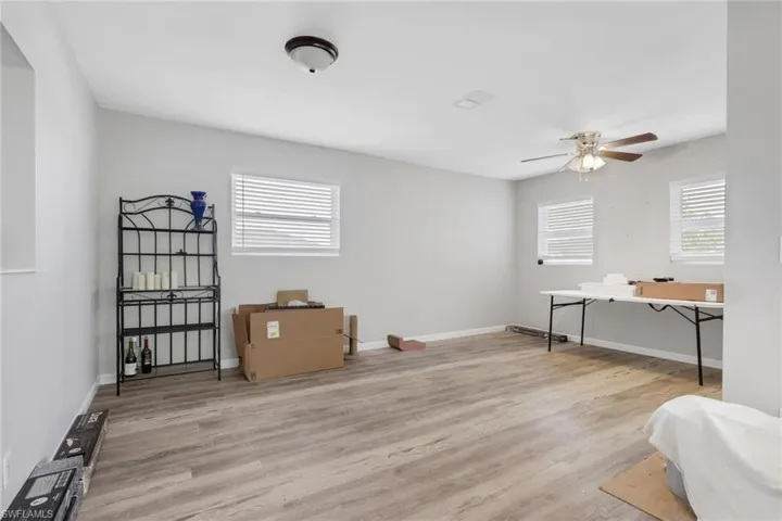 Living area featuring light wood-style flooring and a ceiling fan