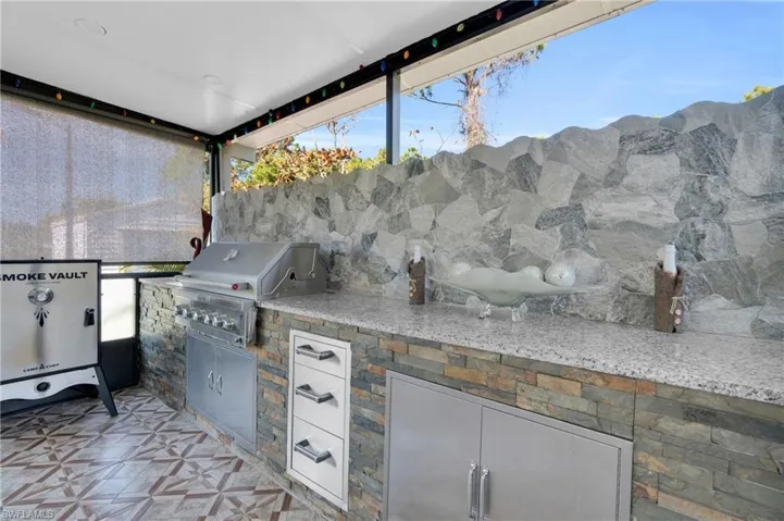 View of patio featuring area for grilling