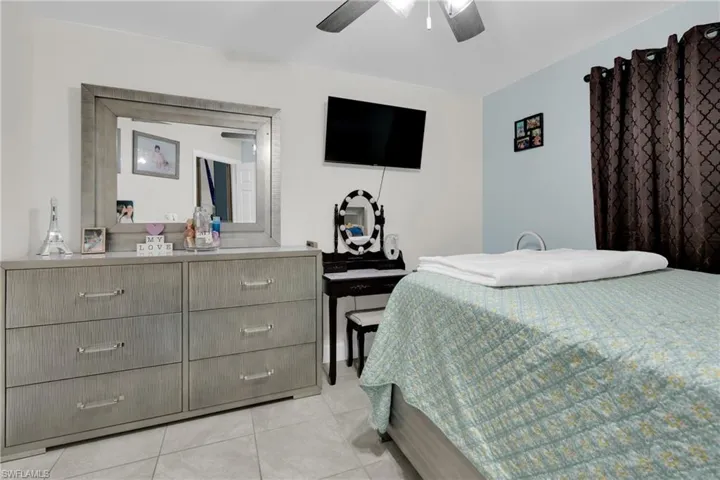 Bedroom with a ceiling fan and light tile patterned floors