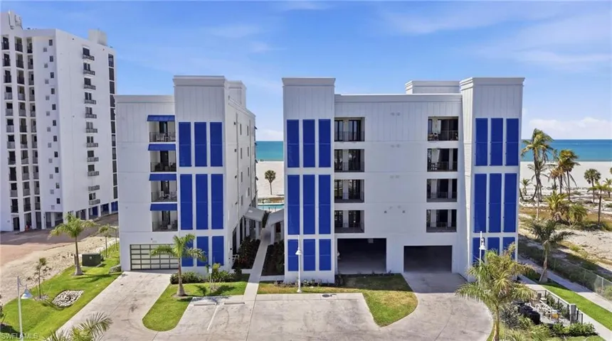 View of apartment building / complex featuring a water view